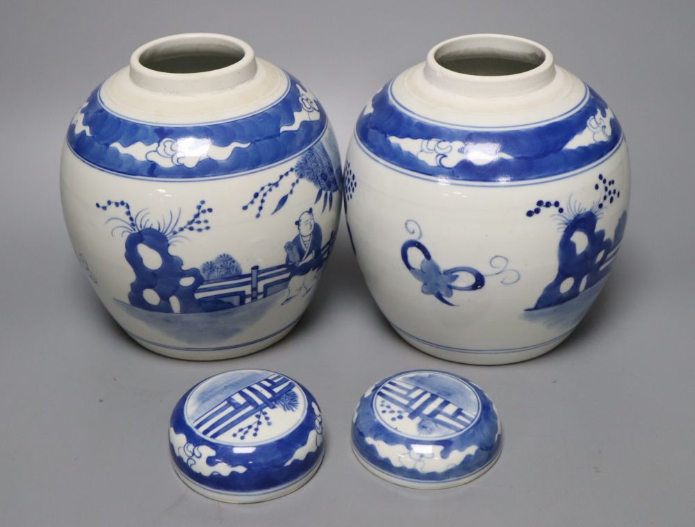 A pair of Chinese porcelain blue and white jars and covers, Qianlong marks but c.1900, 18cm high